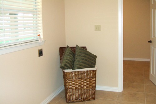 laundry room off kitchen opens to separate storage room/office space