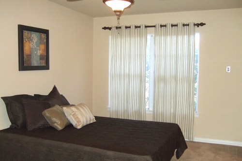 master bedroom with lots of light from two sets of windows