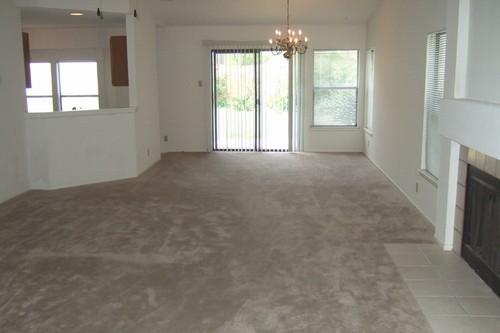 from tiled front entry, living room with fireplace and view of dining area and kitchen